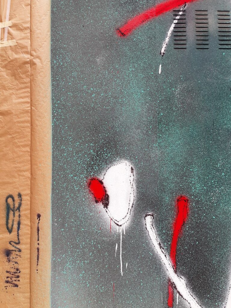 Detalle de la persiana verde con un trazo blanco, uno rojo y la cinta de carrocero en el borde